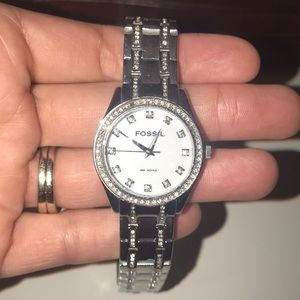 Fossil watch with diamond encircled face.